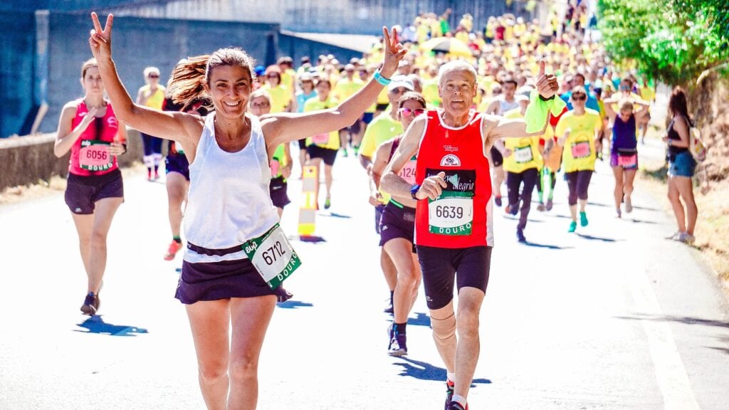 Runners crossing the finish line during a race, celebrating their achievement.