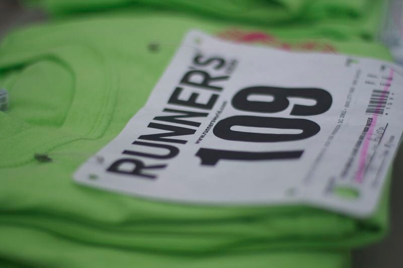 Close-up of a green runner's shirt with race bib number 109.