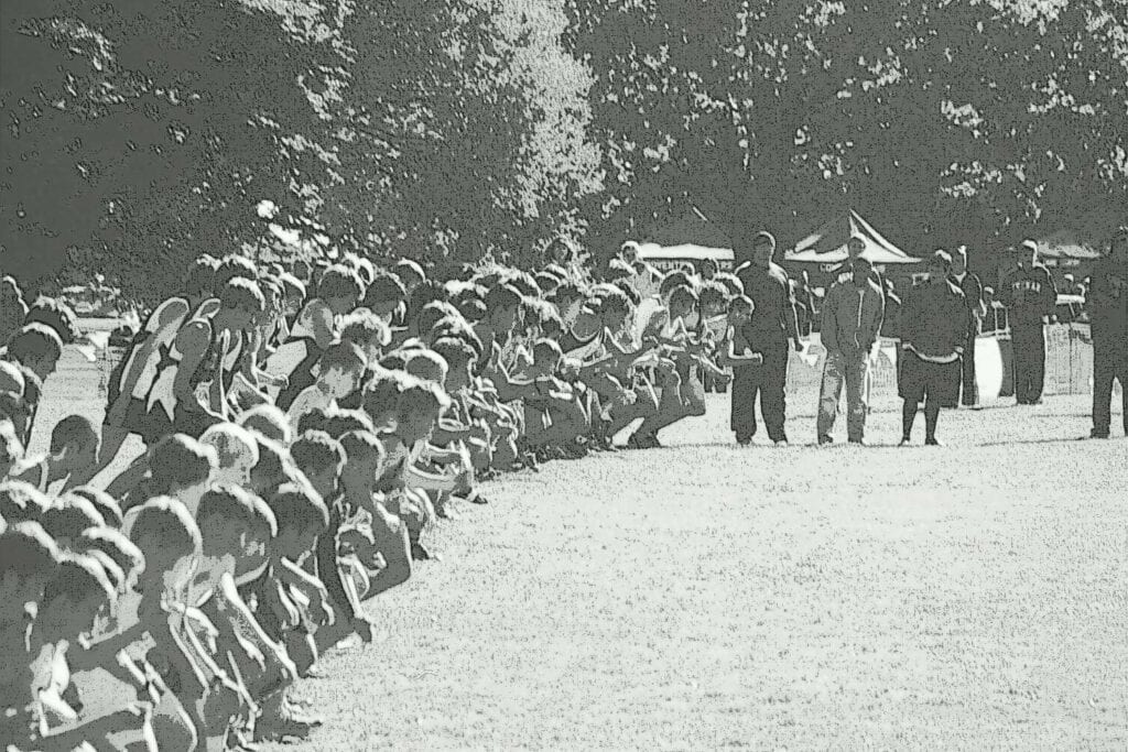 Soldiers lined up in formation with officers inspecting them outdoors.
